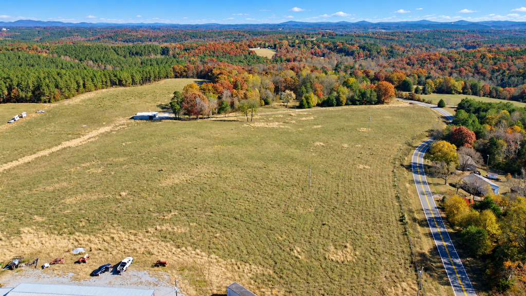 North Carolina land aerial with pasture, road frontage, and mountain views